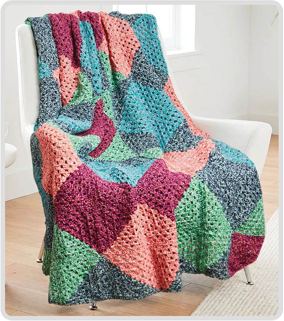Colorful Diamond Dash crochet throw draped over a chair